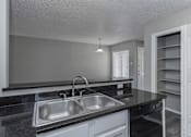 Thumbnail 46 of 47 - A kitchen with a sink and a counter.