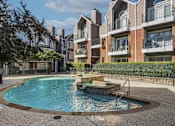 Thumbnail 10 of 47 - A swimming pool in front of apartment buildings.