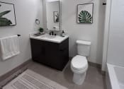 Thumbnail 6 of 38 - a bathroom with a black cabinet and a toilet and a sink