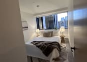 Thumbnail 7 of 38 - a small bathroom with a shower and a bed in it