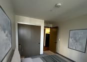Thumbnail 2 of 38 - a bedroom with a bed and a door to a bathroom