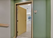 Thumbnail 19 of 46 - an open door leading into a room with a hallway with green walls