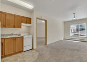 Thumbnail 20 of 46 - a kitchen and living room with a large window and a white dishwasher and sink