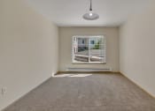Thumbnail 22 of 46 - an empty living room with a large window and carpet