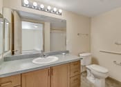Thumbnail 24 of 46 - a bathroom with a sink toilet and a mirror