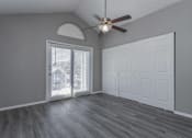 Thumbnail 43 of 47 - A room with a ceiling fan and a sliding glass door.