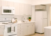 Thumbnail 12 of 38 - Kanekapolei Collection Kitchen Area with appliances and cabinets