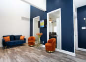Thumbnail 31 of 47 - a living room with blue walls and a couch and chairs