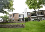 Thumbnail 43 of 47 - the outlook of an apartment building with green grass and trees