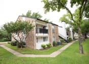 Thumbnail 47 of 47 - the outlook of an apartment building with a lawn and trees