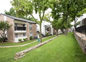 Thumbnail 39 of 47 - the apartments are located next to a green lawn and trees