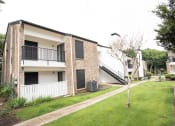 Thumbnail 36 of 47 - the exterior of an apartment building with a lawn and a staircase