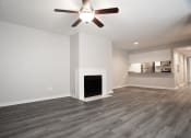 Thumbnail 6 of 47 - a living room with a fireplace and a ceiling fan
