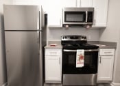 Thumbnail 16 of 47 - a kitchen with stainless steel appliances and white cabinets