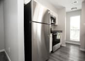 Thumbnail 22 of 47 - a stainless steel refrigerator and stove in a kitchen