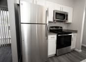 Thumbnail 21 of 47 - a kitchen with stainless steel appliances and white cabinets