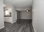 Thumbnail 12 of 47 - an empty living room and kitchen with a ceiling fan