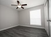 Thumbnail 15 of 47 - an empty room with a ceiling fan and a window