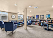 Thumbnail 10 of 70 - A living room with blue chairs and a carpet.