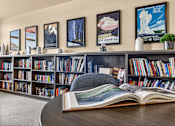 Thumbnail 9 of 70 - A bookshelf filled with books and a book open in front of it.