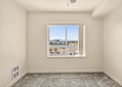 Thumbnail 57 of 70 - A room with a large window overlooking a cityscape.