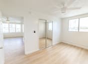 Thumbnail 17 of 23 - A room with a sliding door and a ceiling fan.