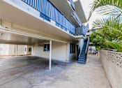 Thumbnail 5 of 23 - A concrete courtyard with a staircase leading to a building.