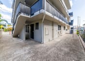 Thumbnail 4 of 23 - A white and blue building with a balcony and a door.