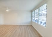 Thumbnail 12 of 23 - A room with wooden flooring and a window with blinds.