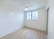 Thumbnail 19 of 23 - A room with a ceiling fan and a window with blinds.