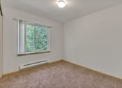 Thumbnail 30 of 46 - an empty room with carpet and a window