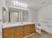 Thumbnail 32 of 46 - the preserve at ballantyne commons apartment bathroom with sink toilet and mirror