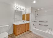 Thumbnail 31 of 46 - a bathroom with a shower sink and toilet and a mirror