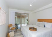Thumbnail 20 of 38 - Kanekapolei Collection Bedroom with mirror doored closets and decor