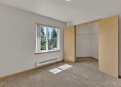 Thumbnail 38 of 46 - an empty room with a window and a closet