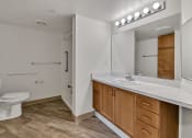 Thumbnail 44 of 46 - a bathroom with a toilet sink and a mirror