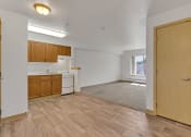 Thumbnail 39 of 46 - an empty living room and kitchen with wood flooring and a window