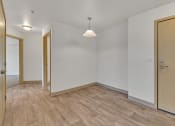 Thumbnail 43 of 46 - a living room with wood flooring and a door to a bedroom