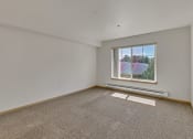 Thumbnail 45 of 46 - a living room with carpet and a window