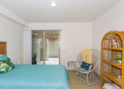 Thumbnail 31 of 38 - Kanekapolei Collection Bedroom with mirror doored closets and decor