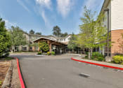 Thumbnail 15 of 46 - the view of a building with a curved road in front of it