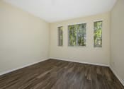 Thumbnail 31 of 35 - Parkside Villas unfurnished bedroom with wooden floors and window