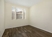 Thumbnail 32 of 35 - Parkside Villas unfurnished bedroom with wooden floors and window