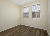 Thumbnail 33 of 35 - Parkside Villas unfurnished bedroom with wooden floors and window