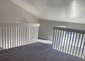 Thumbnail 6 of 9 - an empty room with a staircase and a railing
