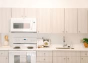 Thumbnail 7 of 38 - Kanekapolei Collection Kitchen area with appliances and cabinets