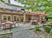 Thumbnail 7 of 46 - a patio with tables and chairs outside of a building