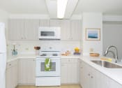 Thumbnail 1 of 38 - Kanekapolei Collection Kitchen area with appliances, cabinet, and counters
