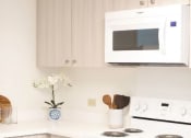 Thumbnail 8 of 38 - Kanekapolei Collection Kitchen area with appliances, cabinet, and counters