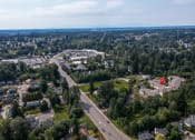 Thumbnail 12 of 46 - an aerial view of a neighborhood with a highway and trees